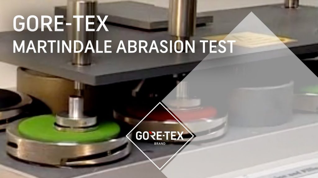 Martindale - stroj na testování oděruodolnosti textilních materiálů.