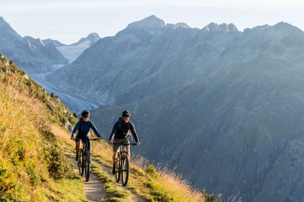 Ultimátní střední vrstva Rab Cinder Ridgeline ze speciální cyklistické kolekce Rab Cinder Light Khaki na kole v přírodě ve dvojici